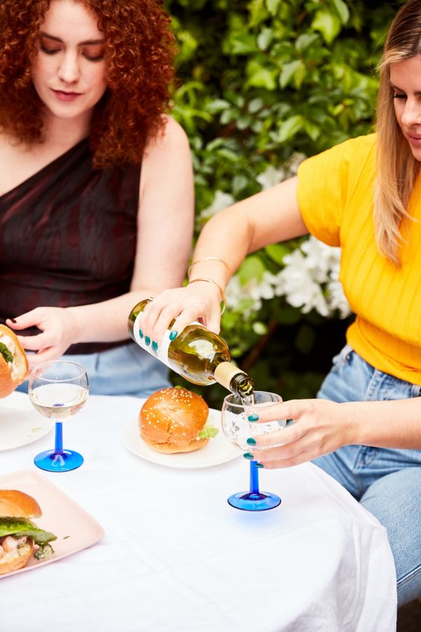Riley pouring a glass of wine
