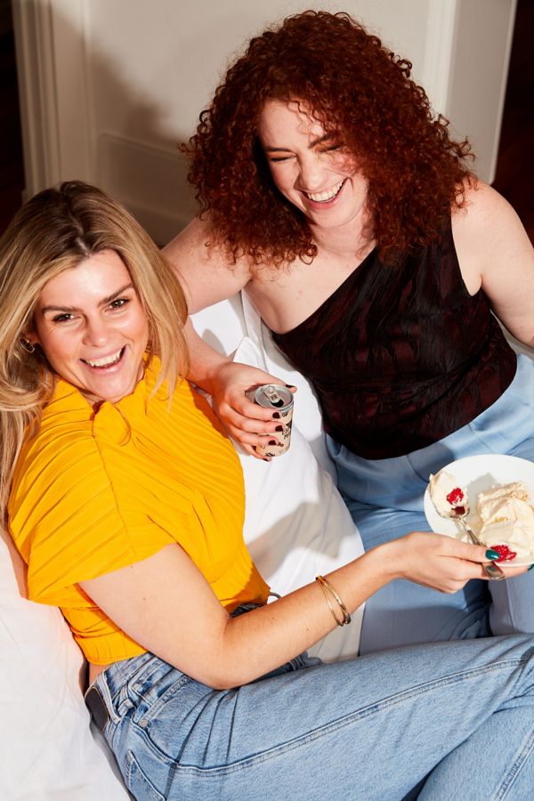 Sophie and Riley laughing on the couch