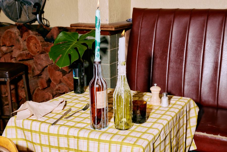 Candles that have been placed in bottles as holders