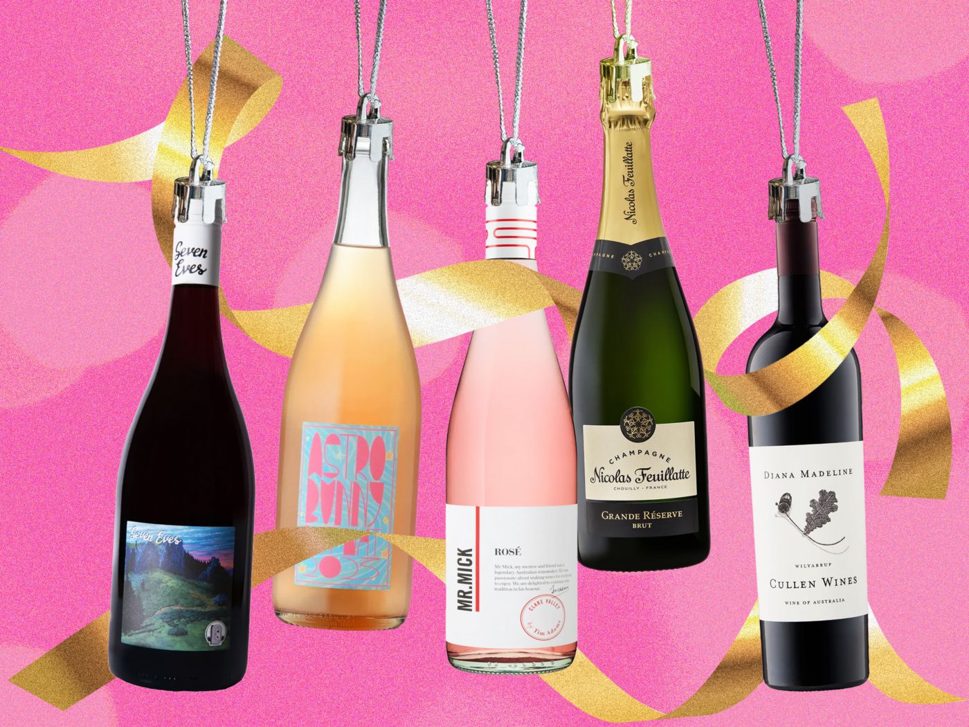 Bottles of wine hanging on silver ribbon against a pink background
