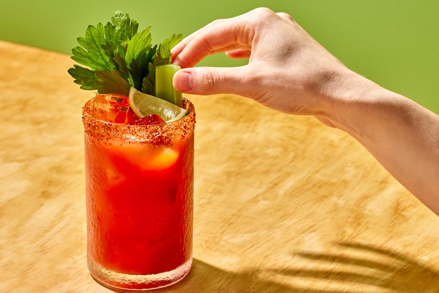 Fixing the garnishes on a spicy Michelada cocktail  