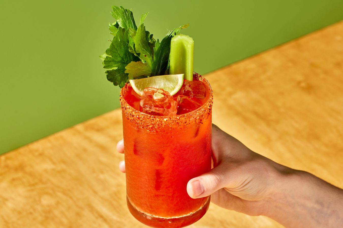 Holding a Michelada cocktail