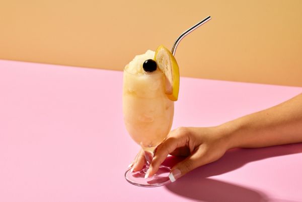 A Frozen Banana Daiquiri with banana and cherry as garnish 