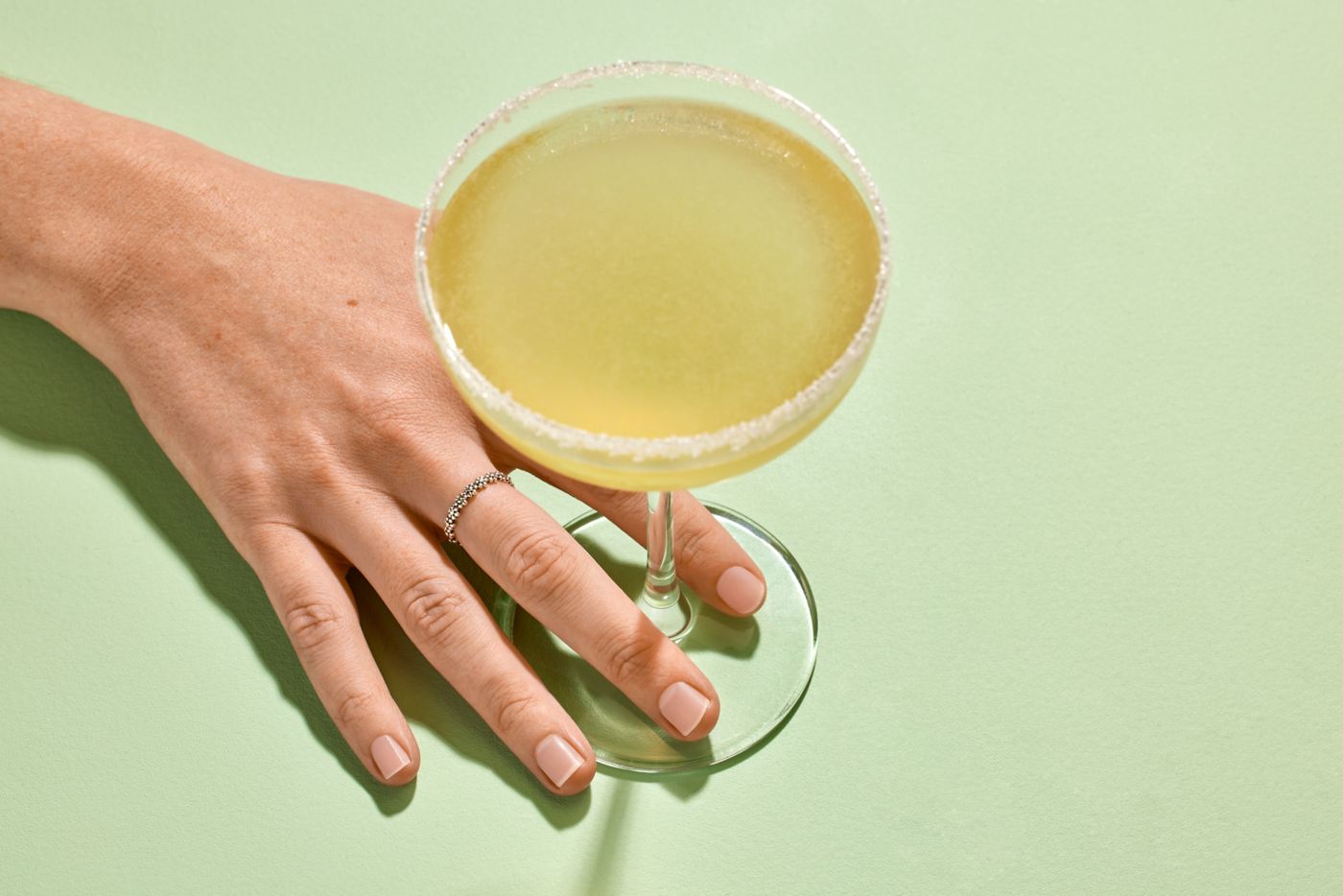 Holding a Sidecar cocktail