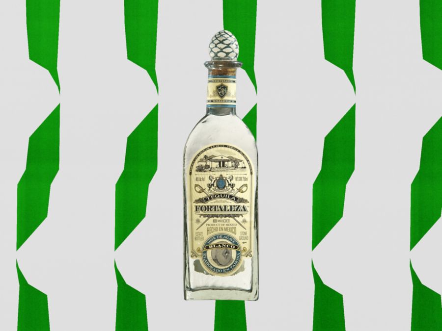 A bottle of Fortaleza Tequila against a green and white background
