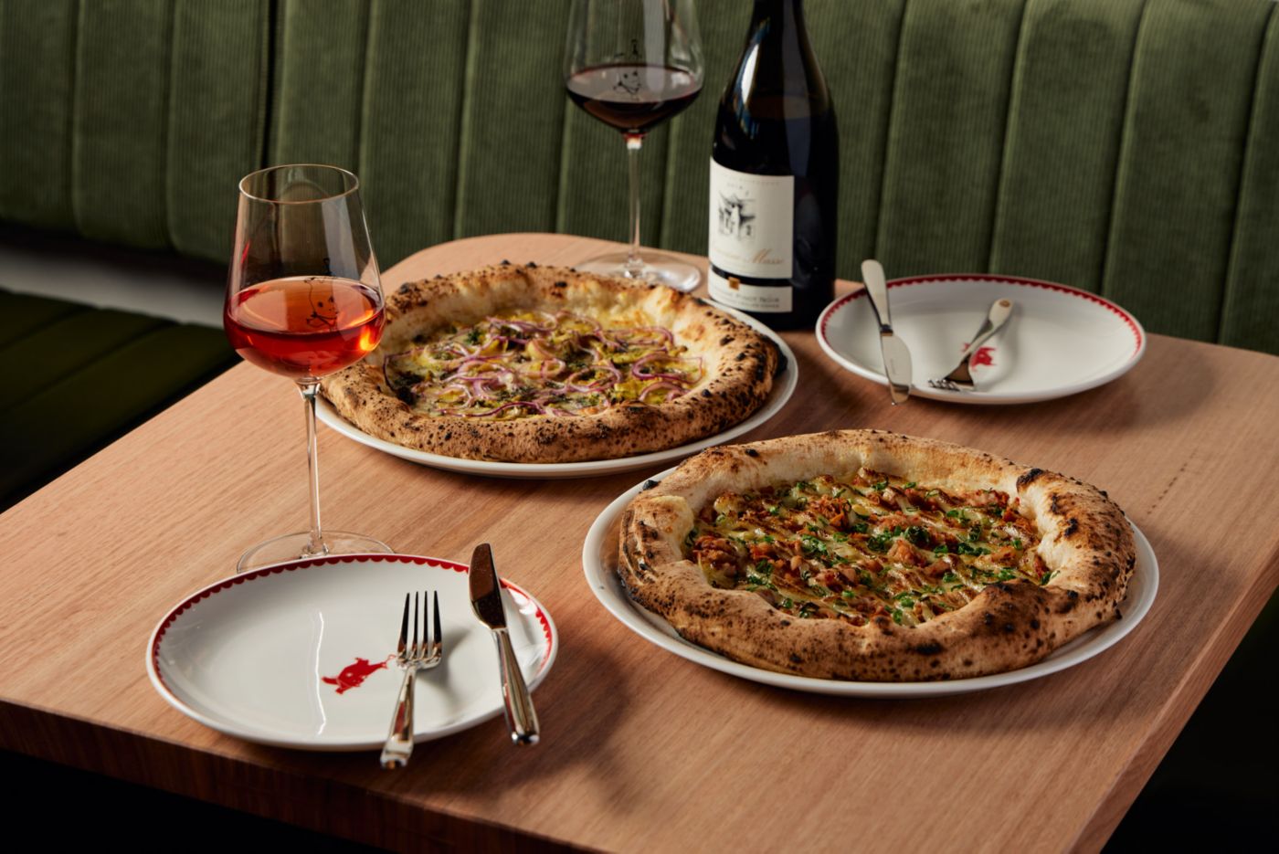 A table setting with pizza and wine at Bandit in Adelaide