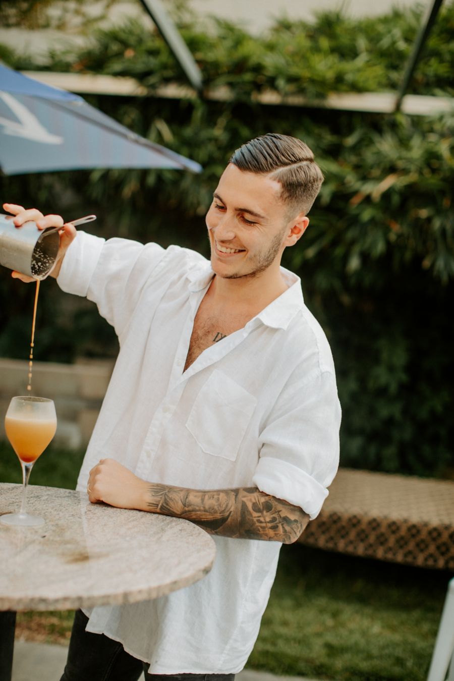 Bartender mixing cocktail at The Trader bar