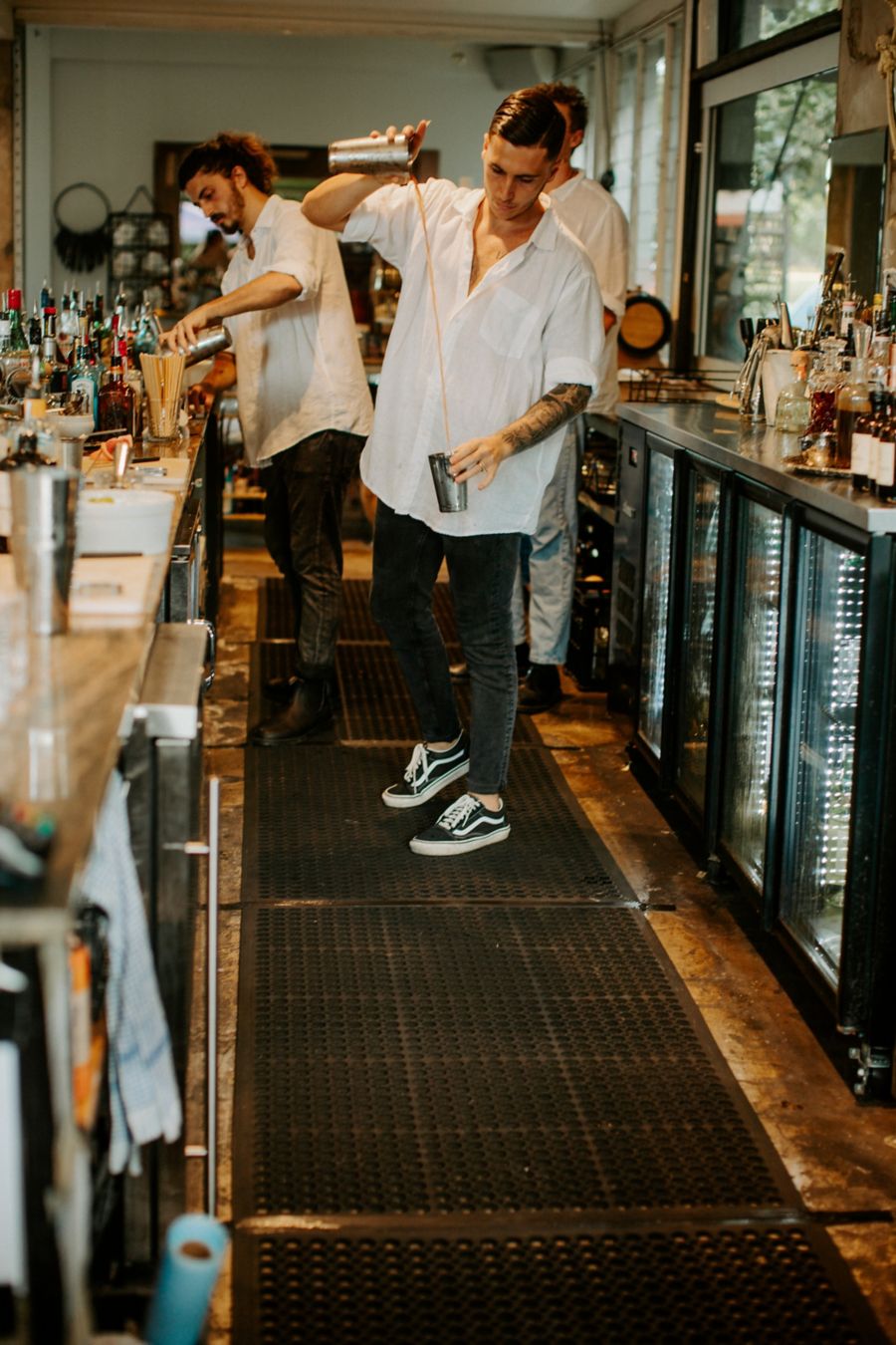 Bartender mixing glasses