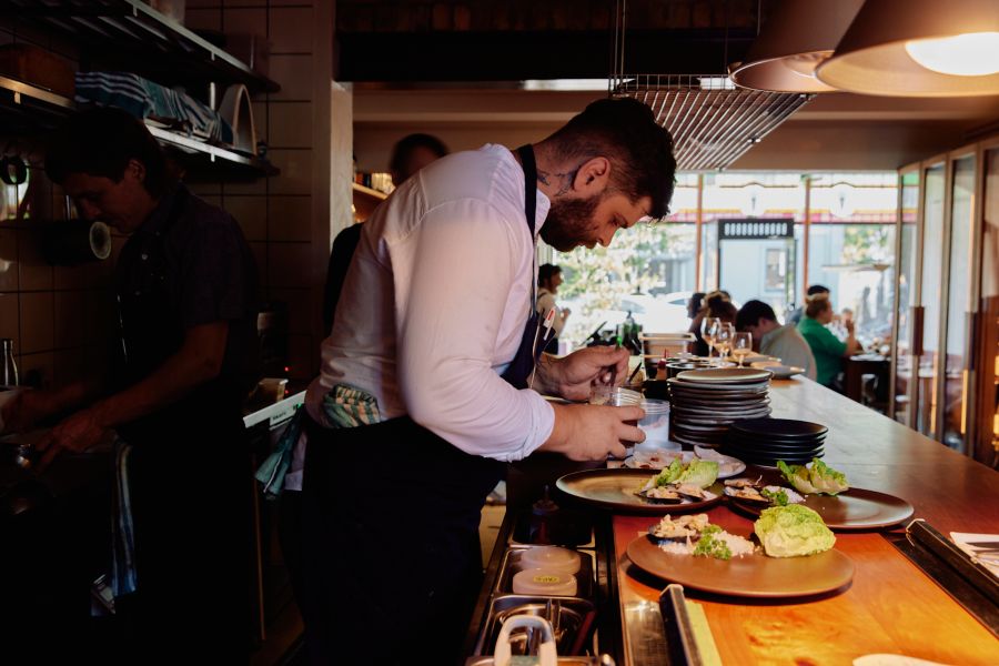 Plating up dishes at Clover in Melbourne