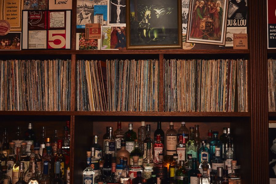 The bar and vinyl collection at The Caterpillar Club
