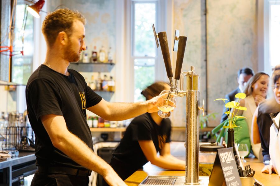 Pouring a beer at Petition Beer Corner, which specialises in brews