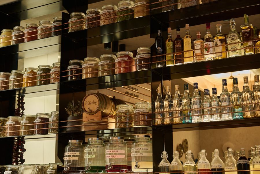 The shelves of drinks behind the bar at Baharat