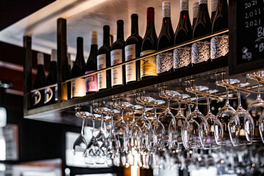 Wine bottles and glasses at Banco Manly