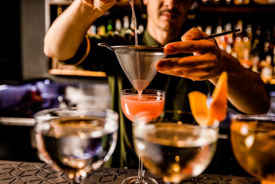 Bartender mixing glasses