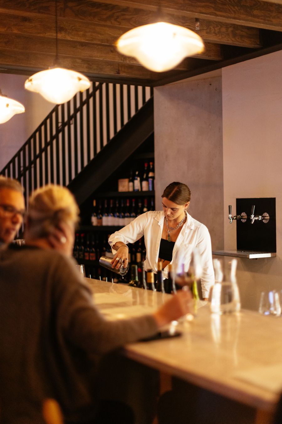 Bartender pouring a drink at  Petite wine bar in Brisbane 