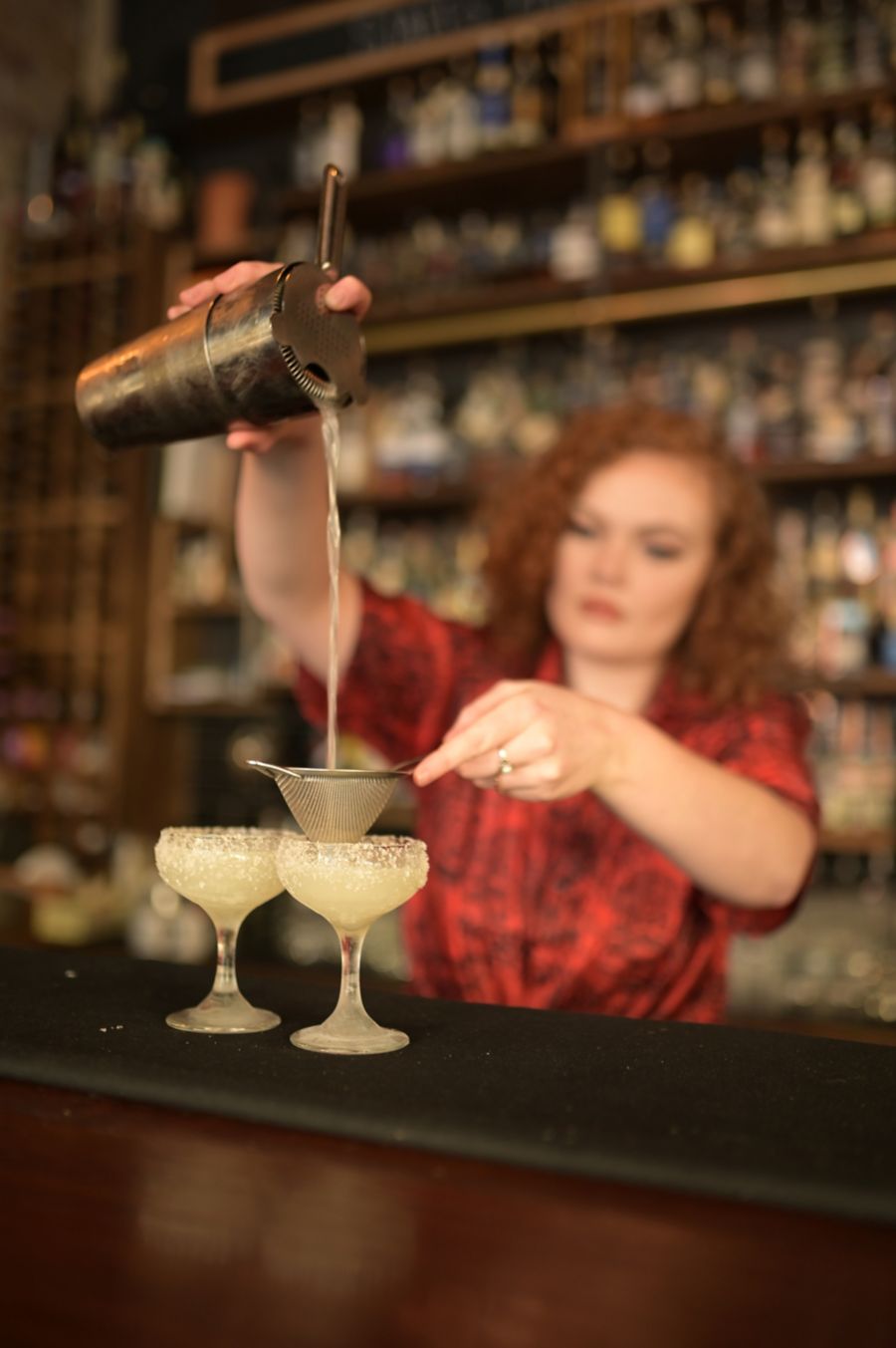 A bartender making cocktails at Cobbler