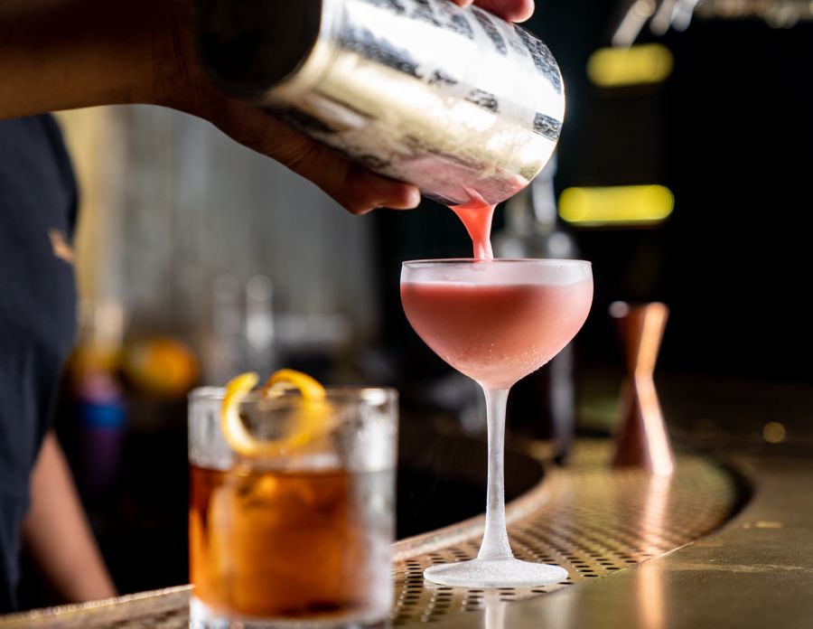 Cocktail being poured from shaker