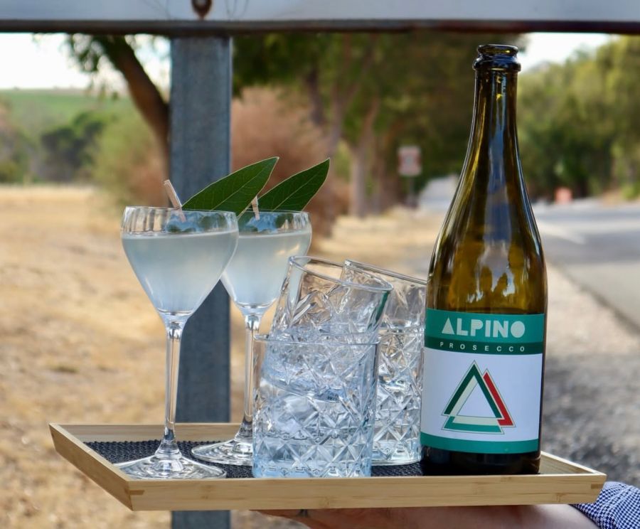 A bottle of wine and glasses outside