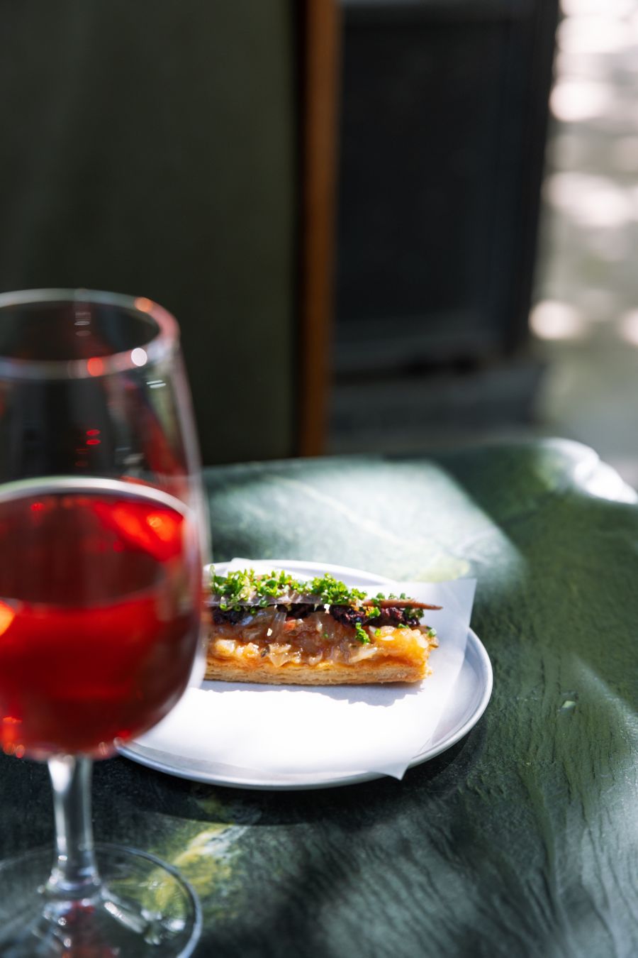 A glass of wine with one of the tasty snacks at Bar Copains