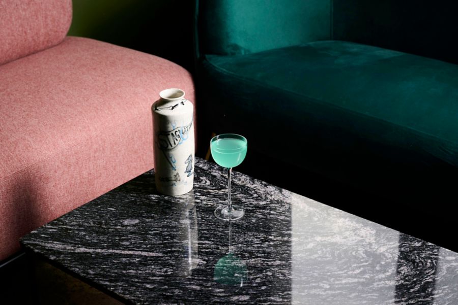 A cocktail and plush seating at Bouvardia