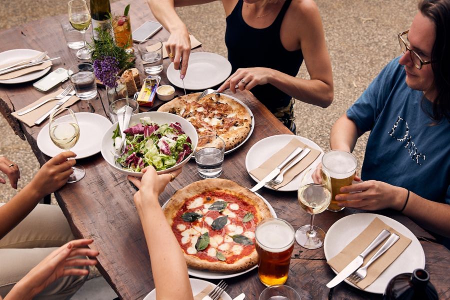 Graba bite of delicious food and cocktails at Lot 100's outdoor seating