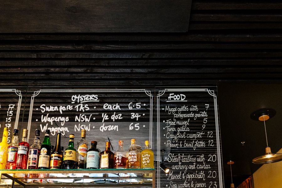 Specials are listed on the mirrored board at The Walrus