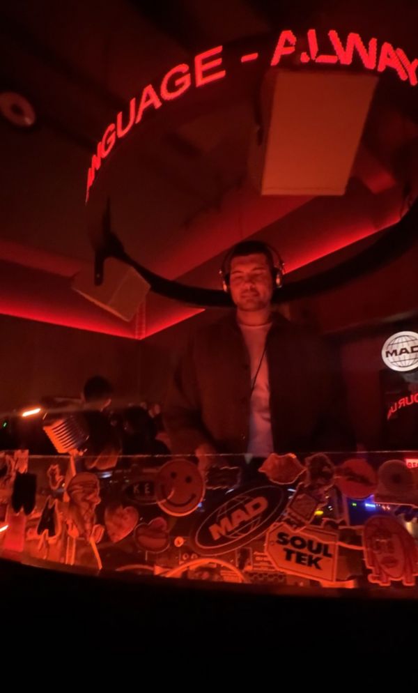 A DJ playing a set in a NYC bar 