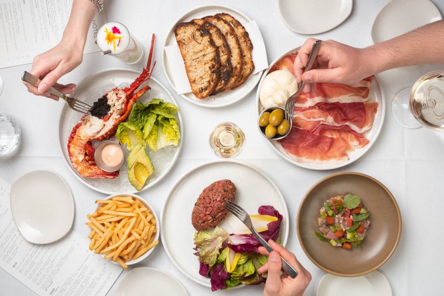 People enjoying food and drinks at Botanical Hotel