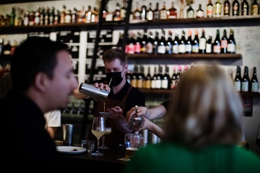 man enjoying his drink on bar counter