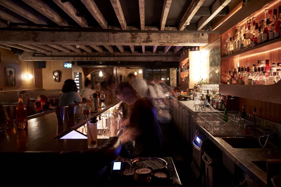 people sitting in Double Deuce Lounge with drinks and food