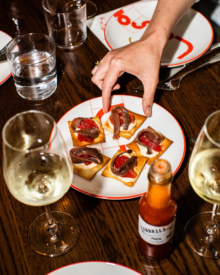 Delicious Snacks at La Salut Sydney Made With An Anchovy and Tomato With a Generous Cloud of Manchego-Cheese Custard on a Cracker..