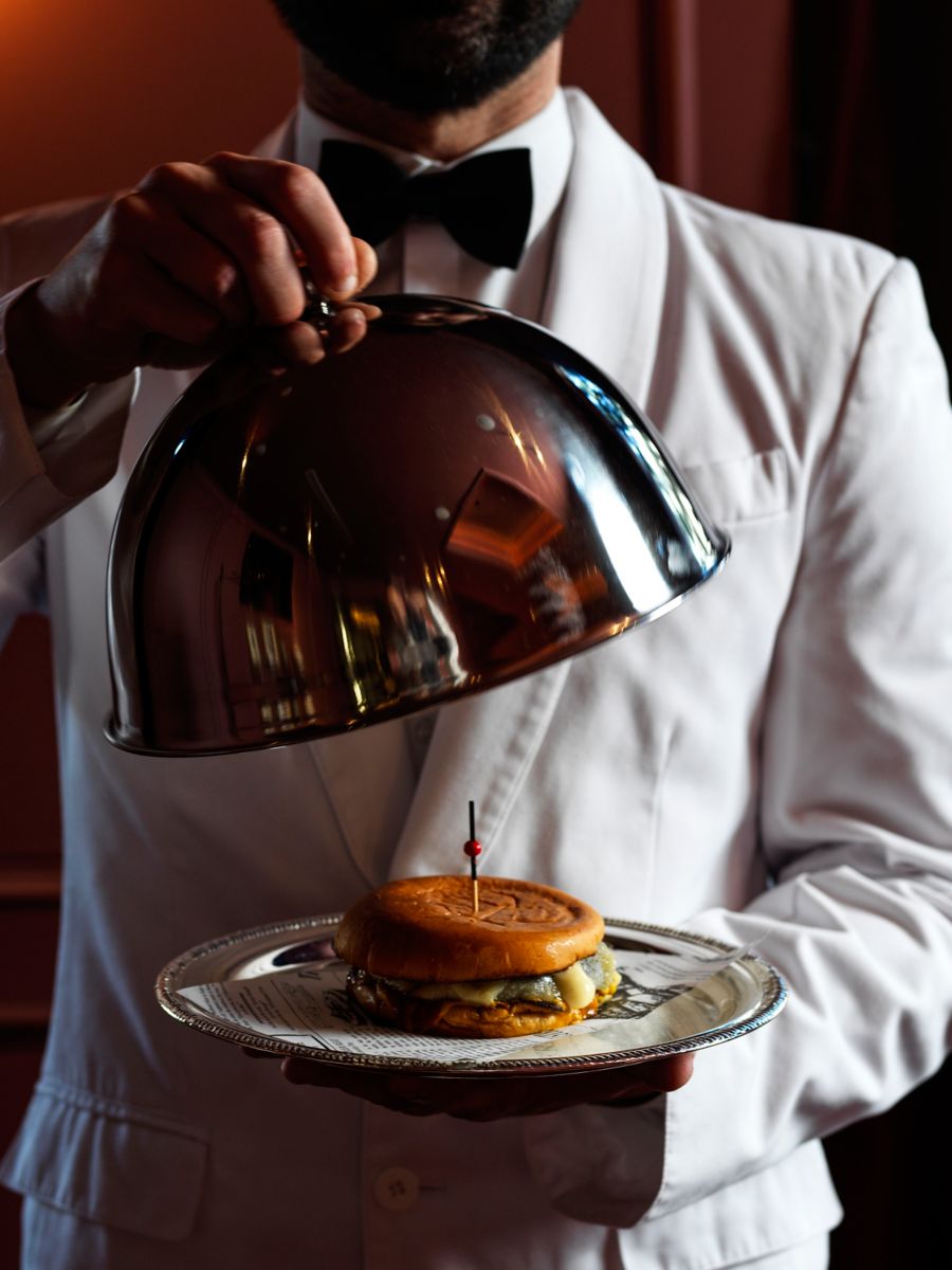 A burger under a cloche at The Bar at InterContinental Sydney Double Bay