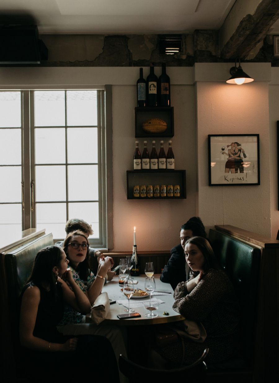 A group dining in a booth at Canberra's Bar Rochford