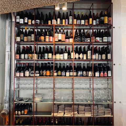 a glass filled with water and snacks on a plate