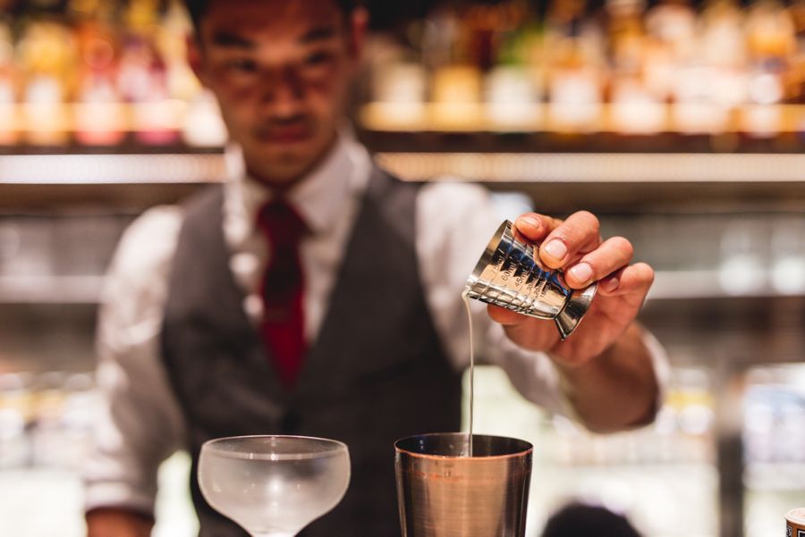 A bartender mixes a drink at Bancho, Sydney CBD