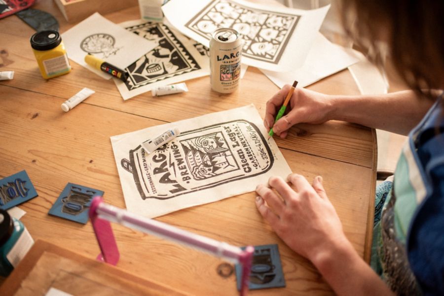 Louis signing linocut artwork for LARGO