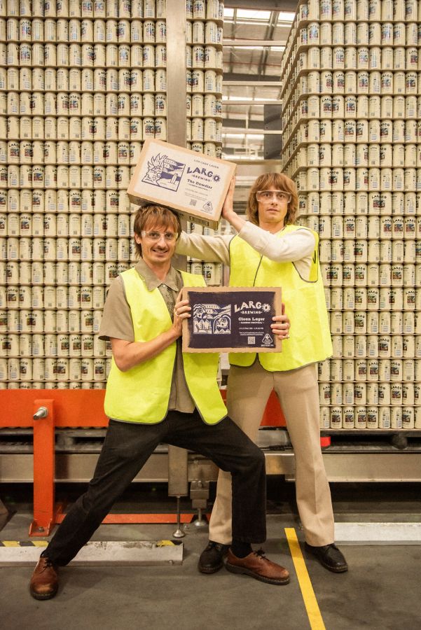 Oli and Louis holding cases of LARGO beer at the brewery