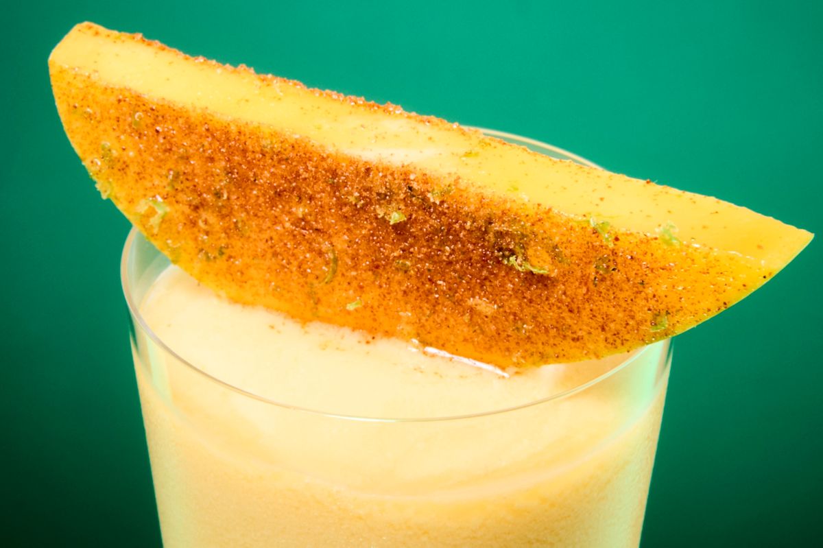 The Mango Colada is garnished with a Tajin-dipped mango