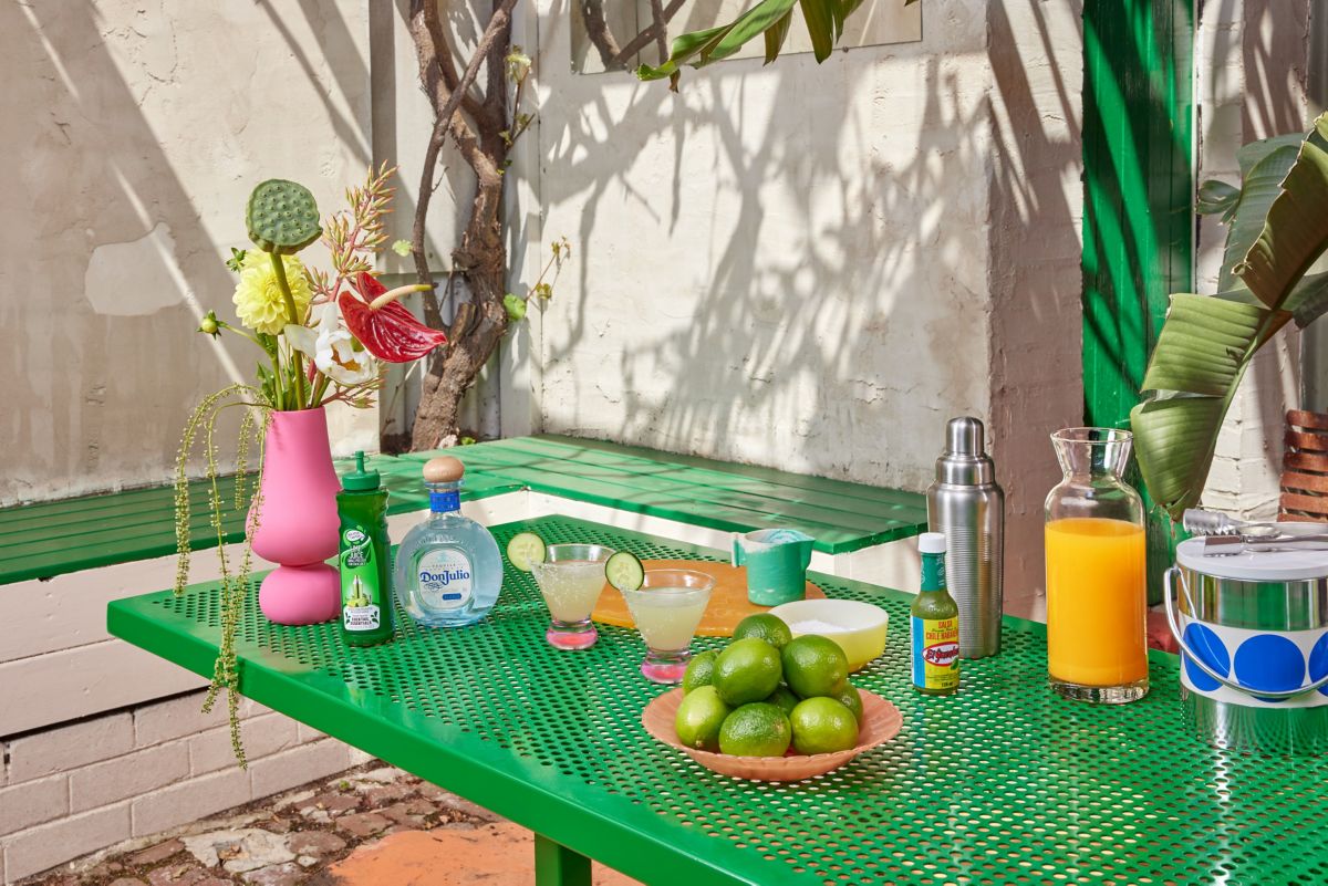A table setting with Spicy Pineapple Margaritas and ingredients