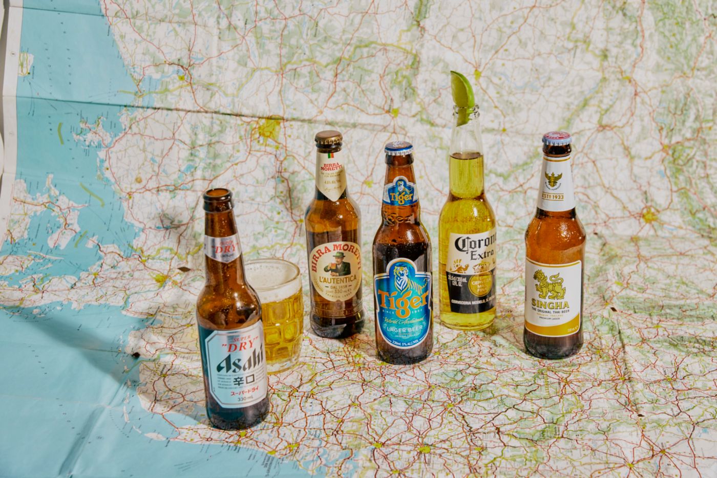 Bottles of international beers on a map