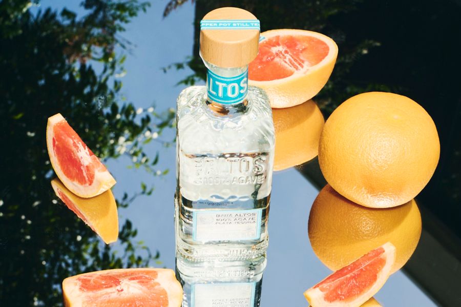 A bottle of the Altos Plata Tequila with citrus
