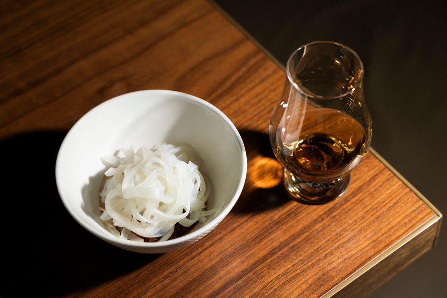 A dram of whisky with a delicate seafood dish served at Saint Peter in Sydney