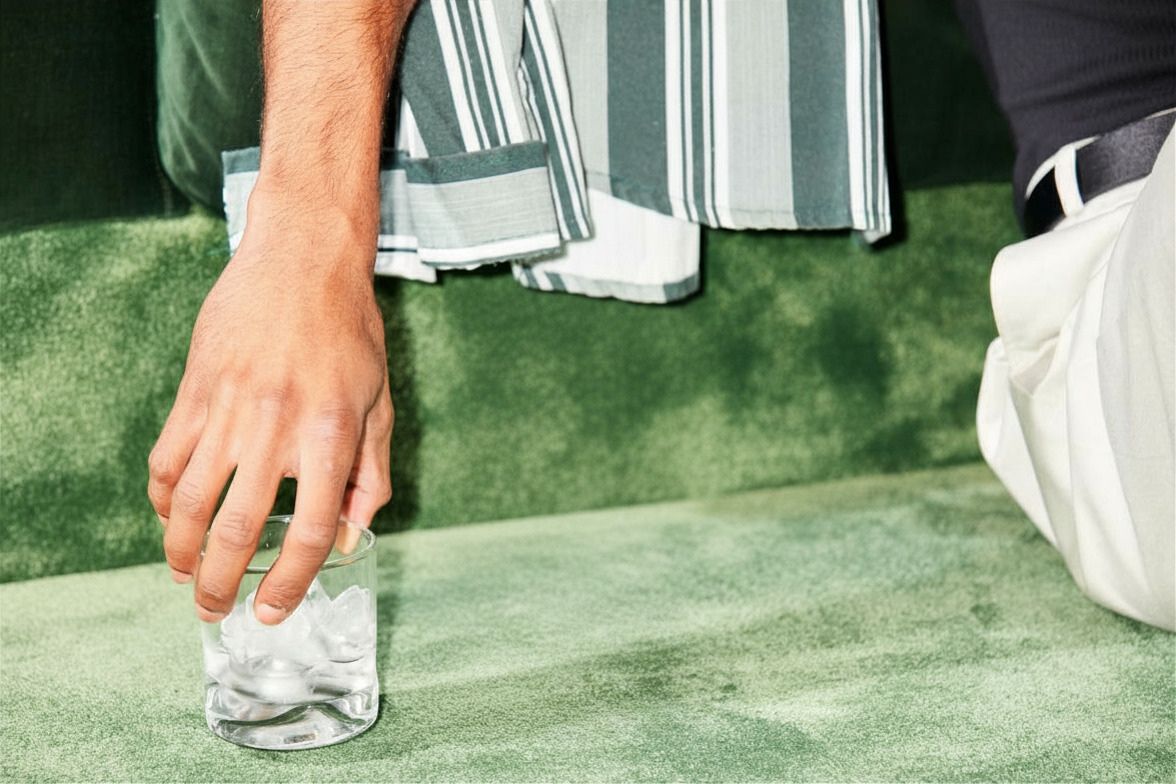 Holding a glass of vodka on ice