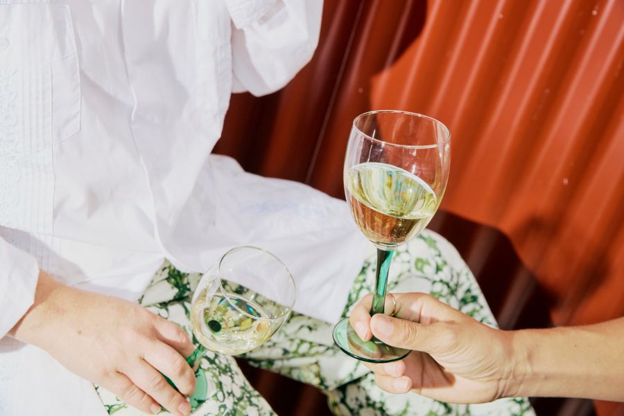 Two people with a glass of white wine