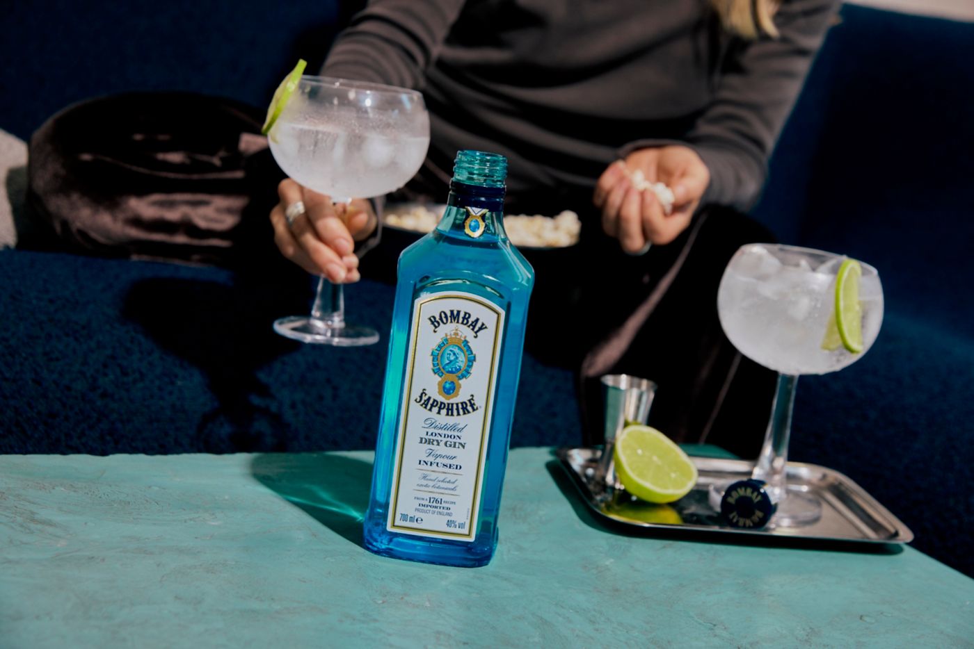 Sitting on a couch with a bowl of popcorn and a Bombay Sapphire G&T 