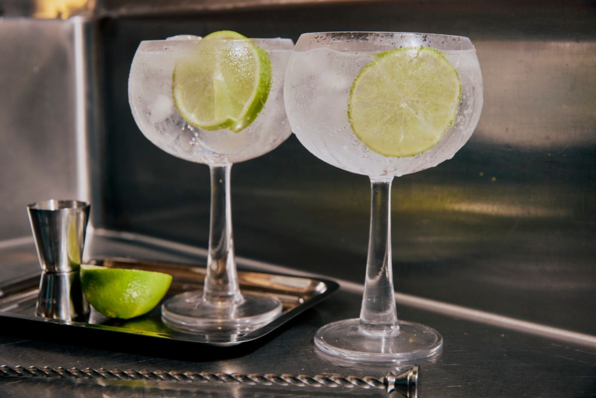 Two glasses of G&T with lime wedges 