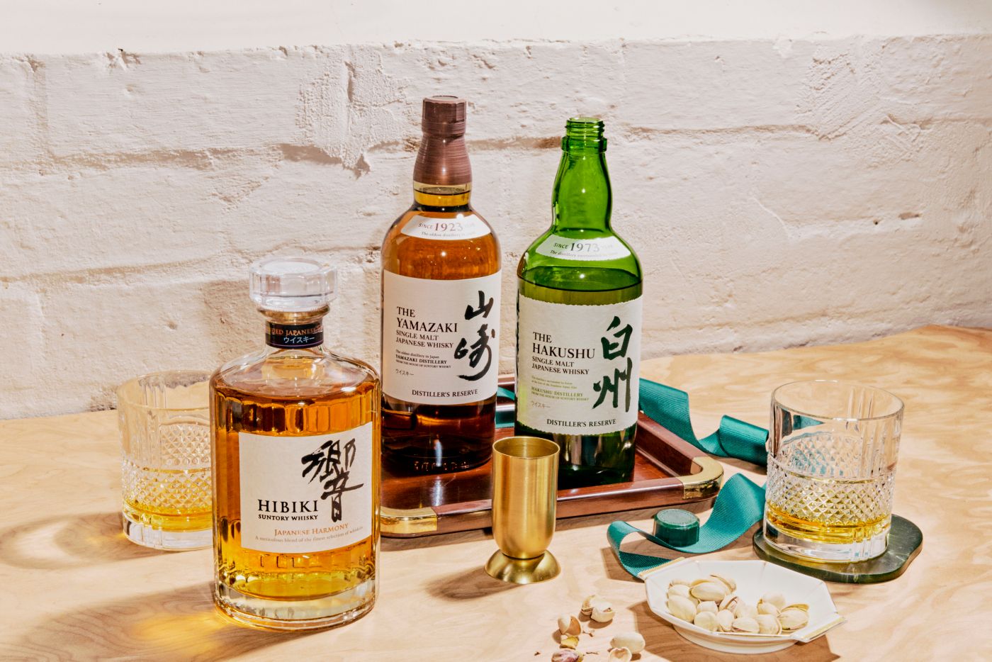 Three Japanese whiskies from House of Suntory with glasses on a tray 