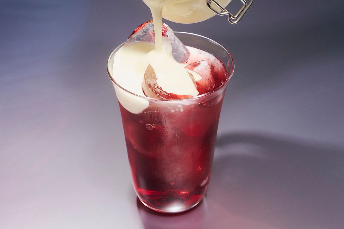 Layering the cream float on to the Cherry Cream Shrub cocktail