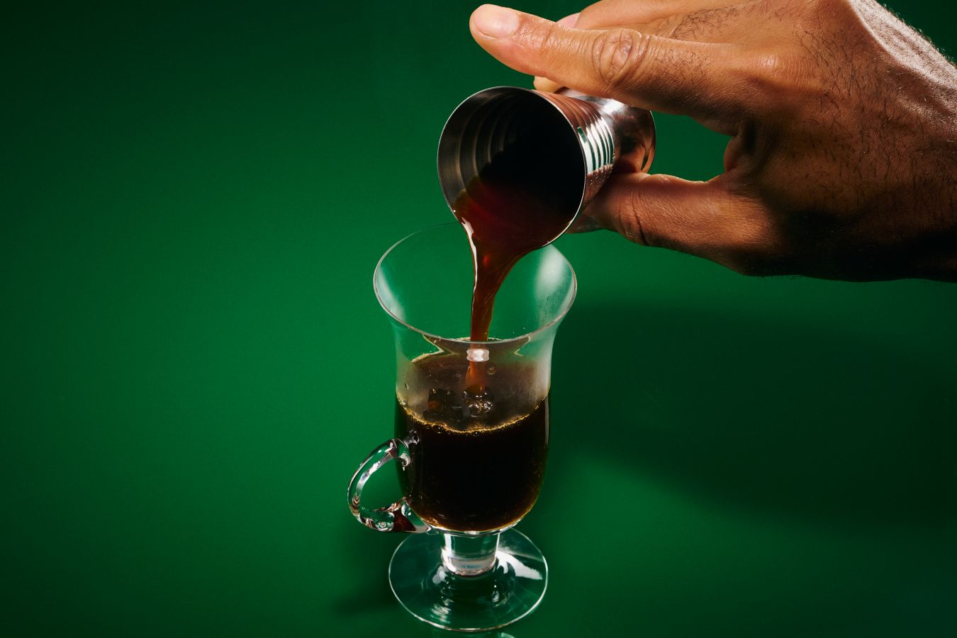Pouring coffee into the glass for an Irish Coffee Creamer