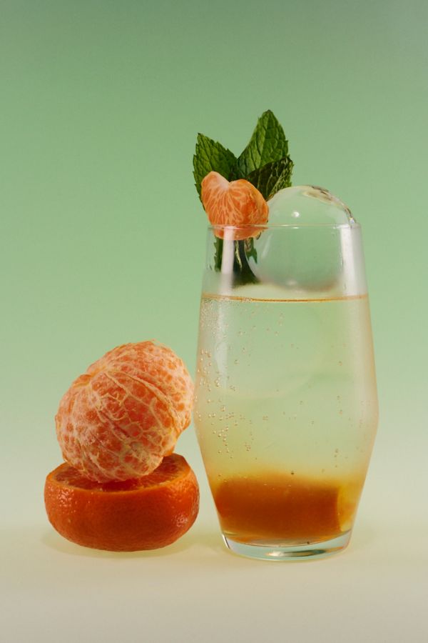 The Mandarin Hugo Spritz is garnished with fresh mandarin and mint